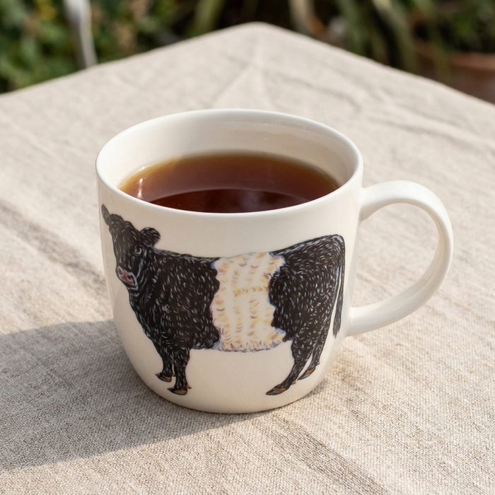 Belted Galloway Cow Mug (medium round sided) styled on the table