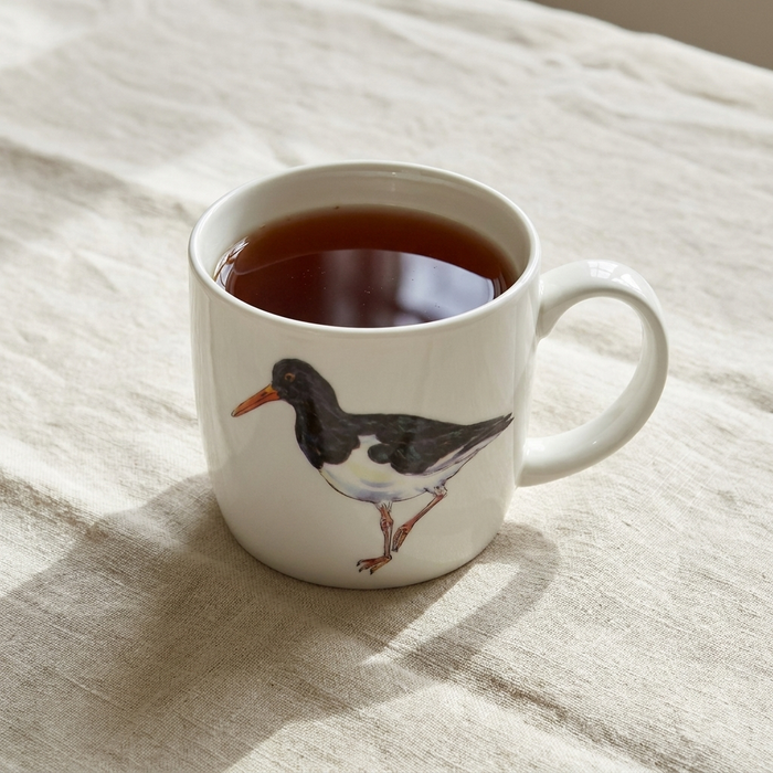 Oystercatcher Mug (medium round sided) styled on the table