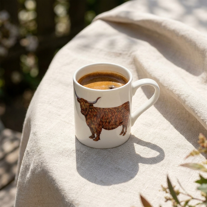 Highland Cow Small Mug styled on the table
