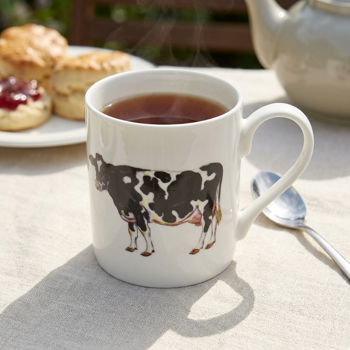 Holstein-Friesian Cow Mug (medium straight sided) styled on the table
